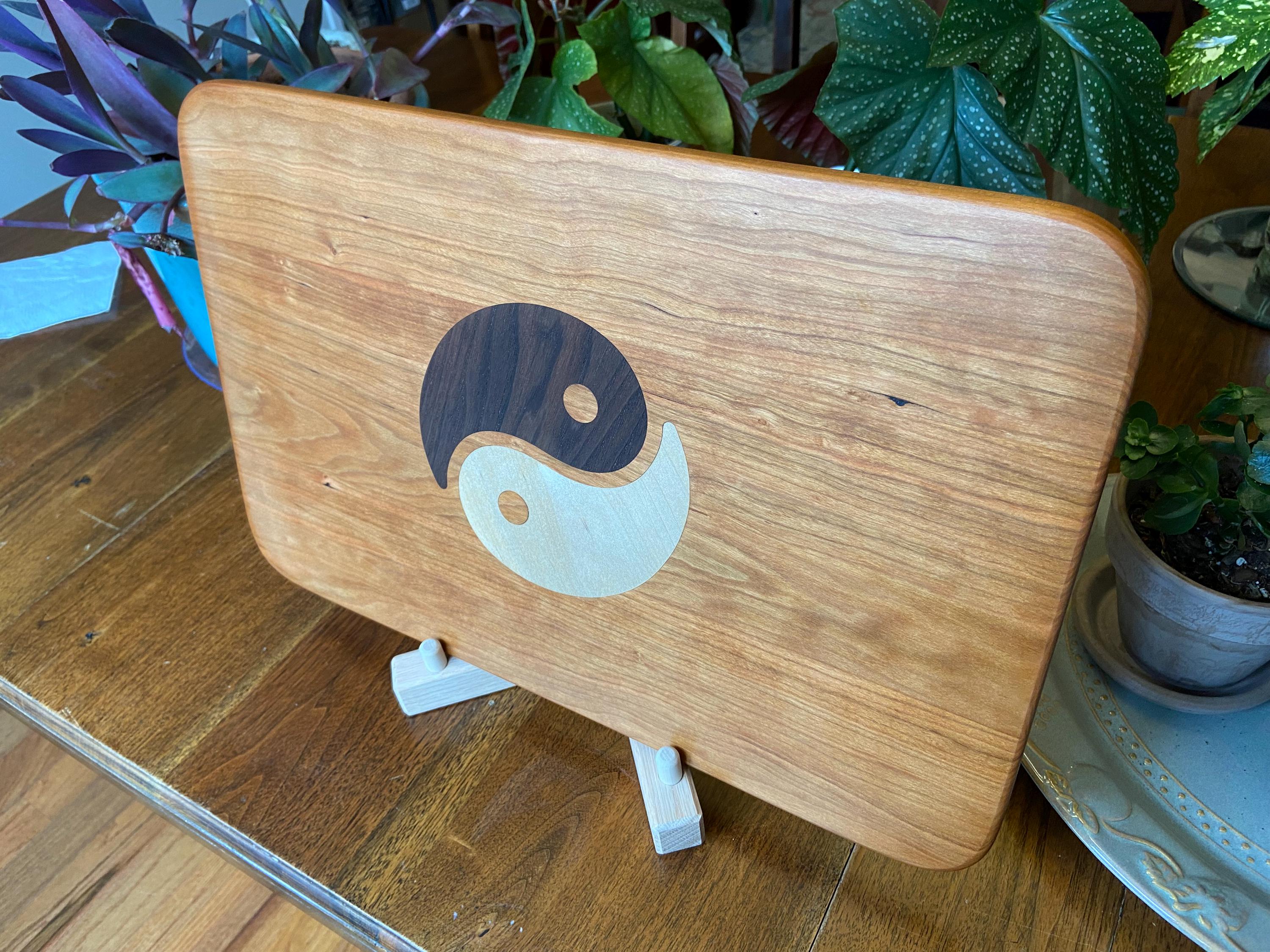 Cherry charcuterie board with Yin Yang inlay made from Peruvian Walnut and Maple.