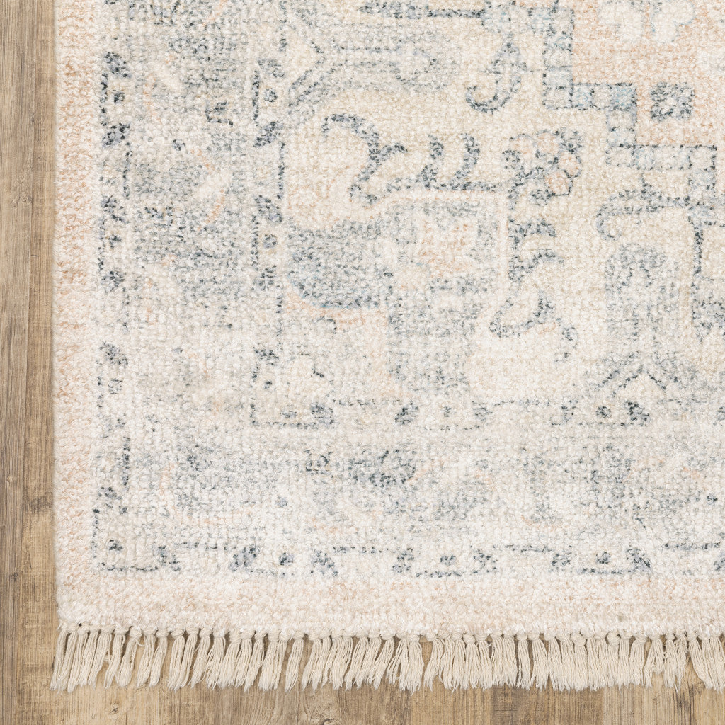 5 X 8 Beige And grey Oriental Hand Loomed Stain Resistant Area Rug With Fringe