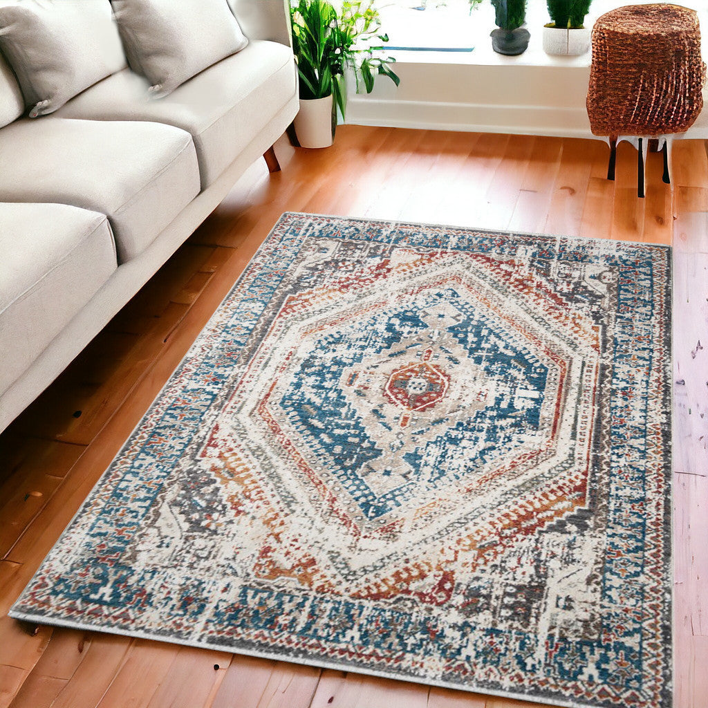 5 X 8 Teal Taupe and Rust Geometric Distressed Area Rug With Fringe