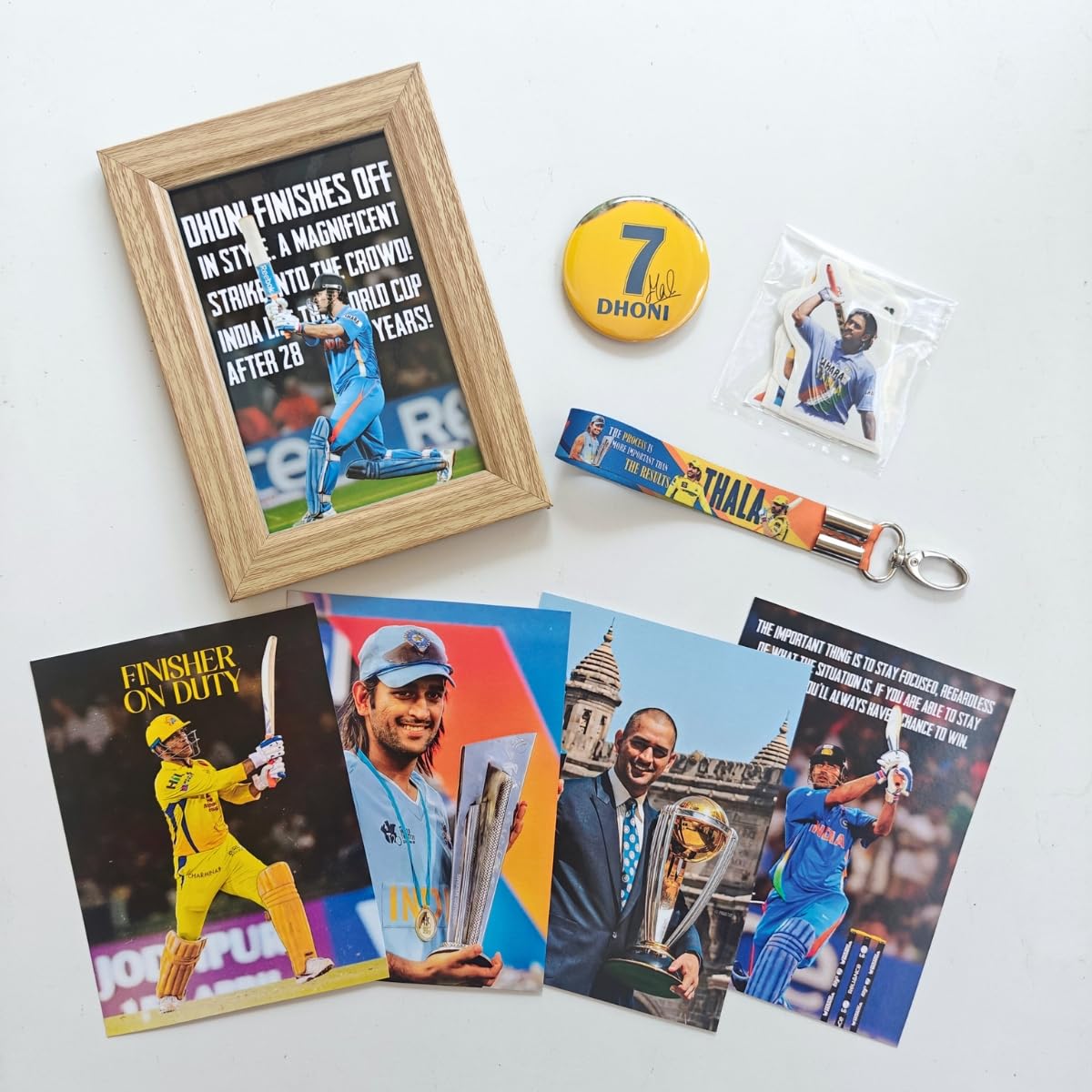 Tenorarts Ms Dhoni Gift Box Merchandise - 5X7 Inches Laminated Photo Frame,1 Dhoni Keychain, 1 Badge, 4 4X6 Inches Posters, Shap