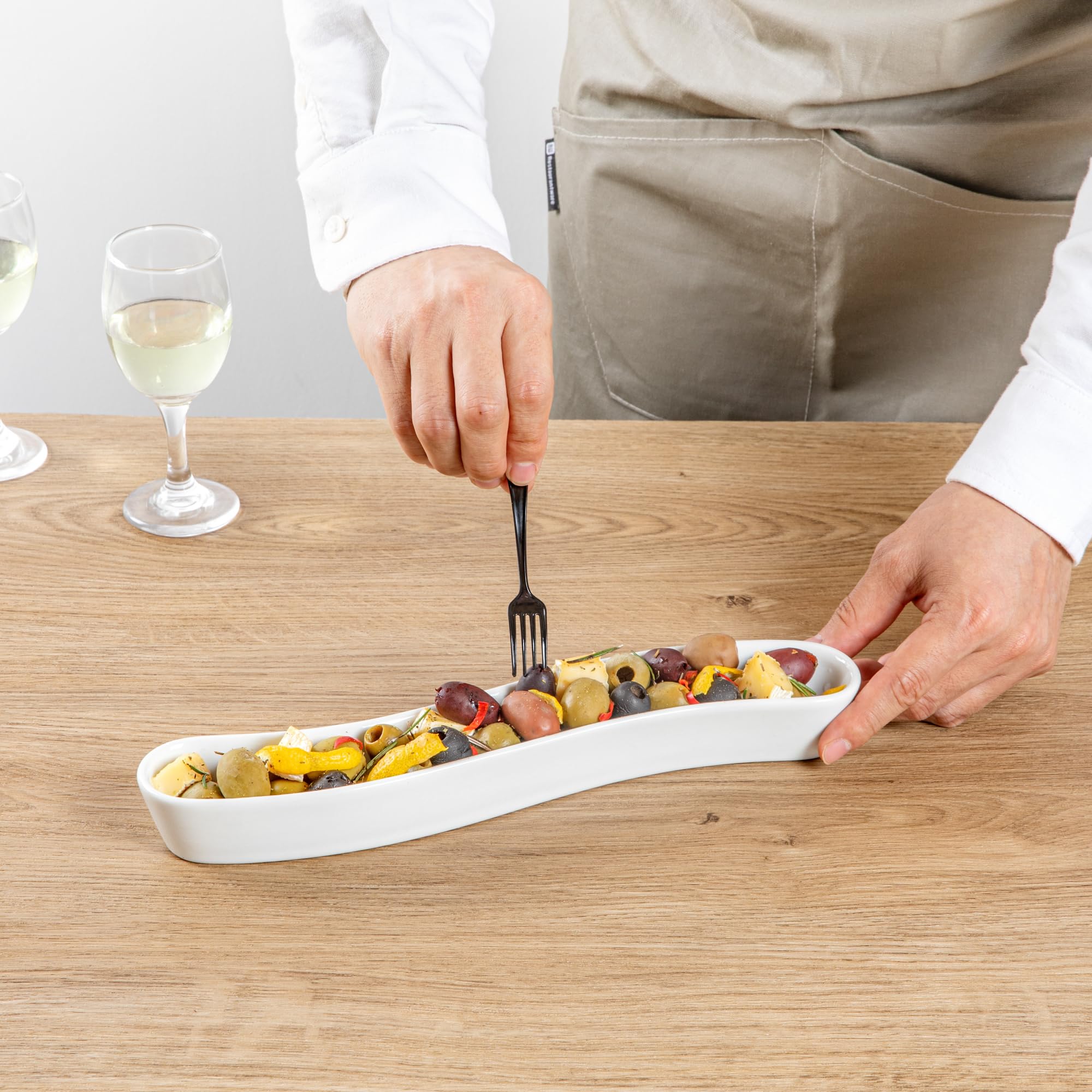 Restaurantware Swerve 10 Ounce Olive Plate 1 Curved Olive Tray - Medium Chip Resistant White Porcelain Olive Canoe Dishwasher Sa