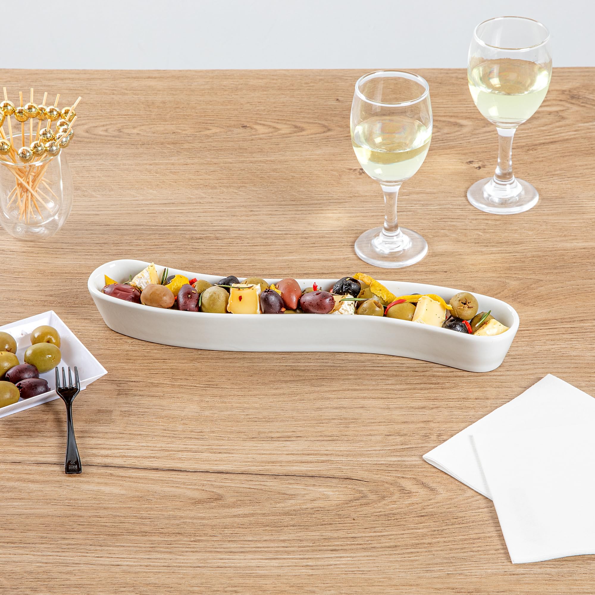 Restaurantware Swerve 10 Ounce Olive Plate 1 Curved Olive Tray - Medium Chip Resistant White Porcelain Olive Canoe Dishwasher Sa