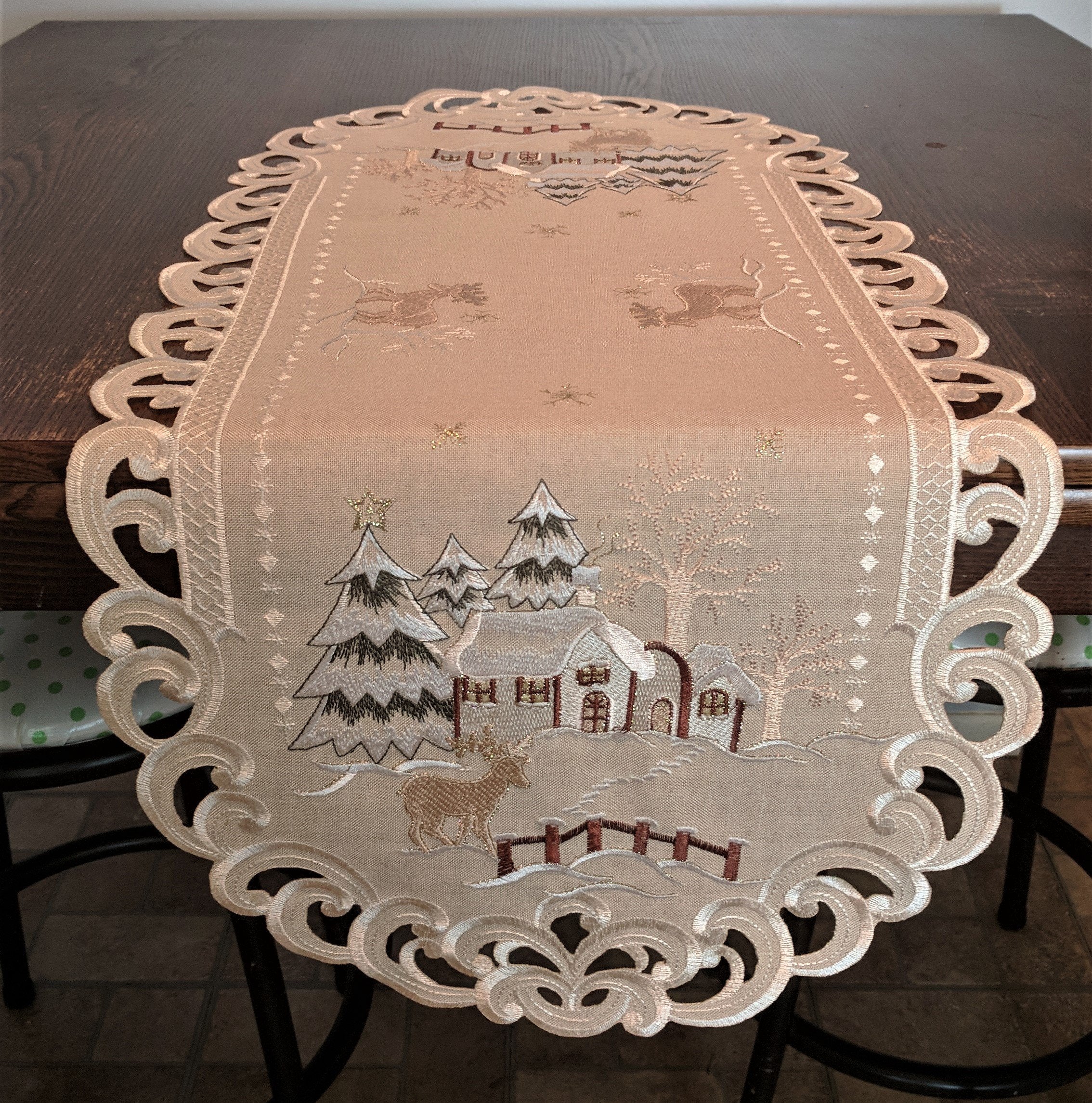 Doily Boutique Christmas Table Runner with Reindeer and Cabin on Tan Burlap Style Material Size 54 x 15 inches