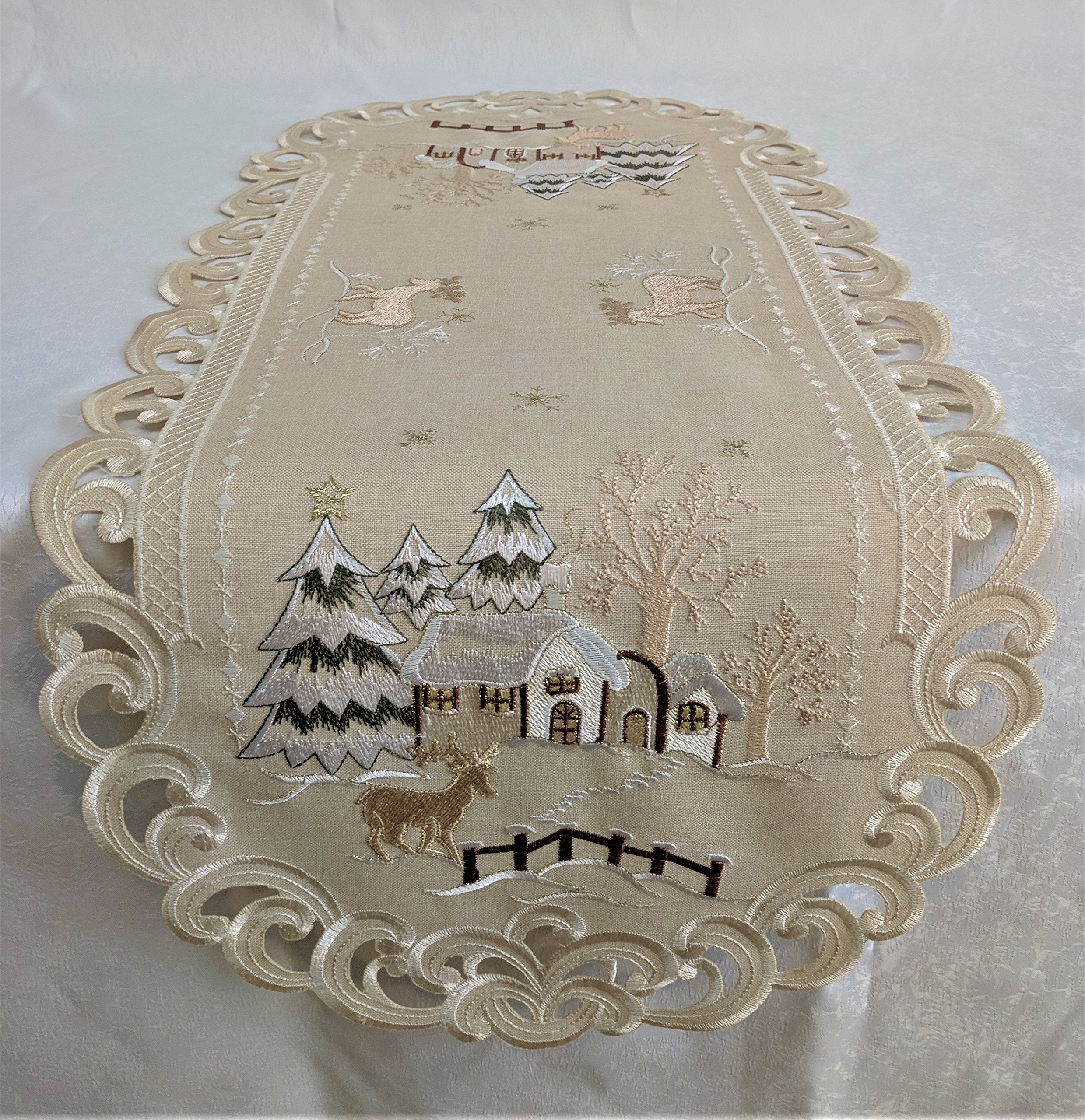 Doily Boutique Christmas Table Runner with Reindeer and Cabin on Tan Burlap Style Material Size 54 x 15 inches