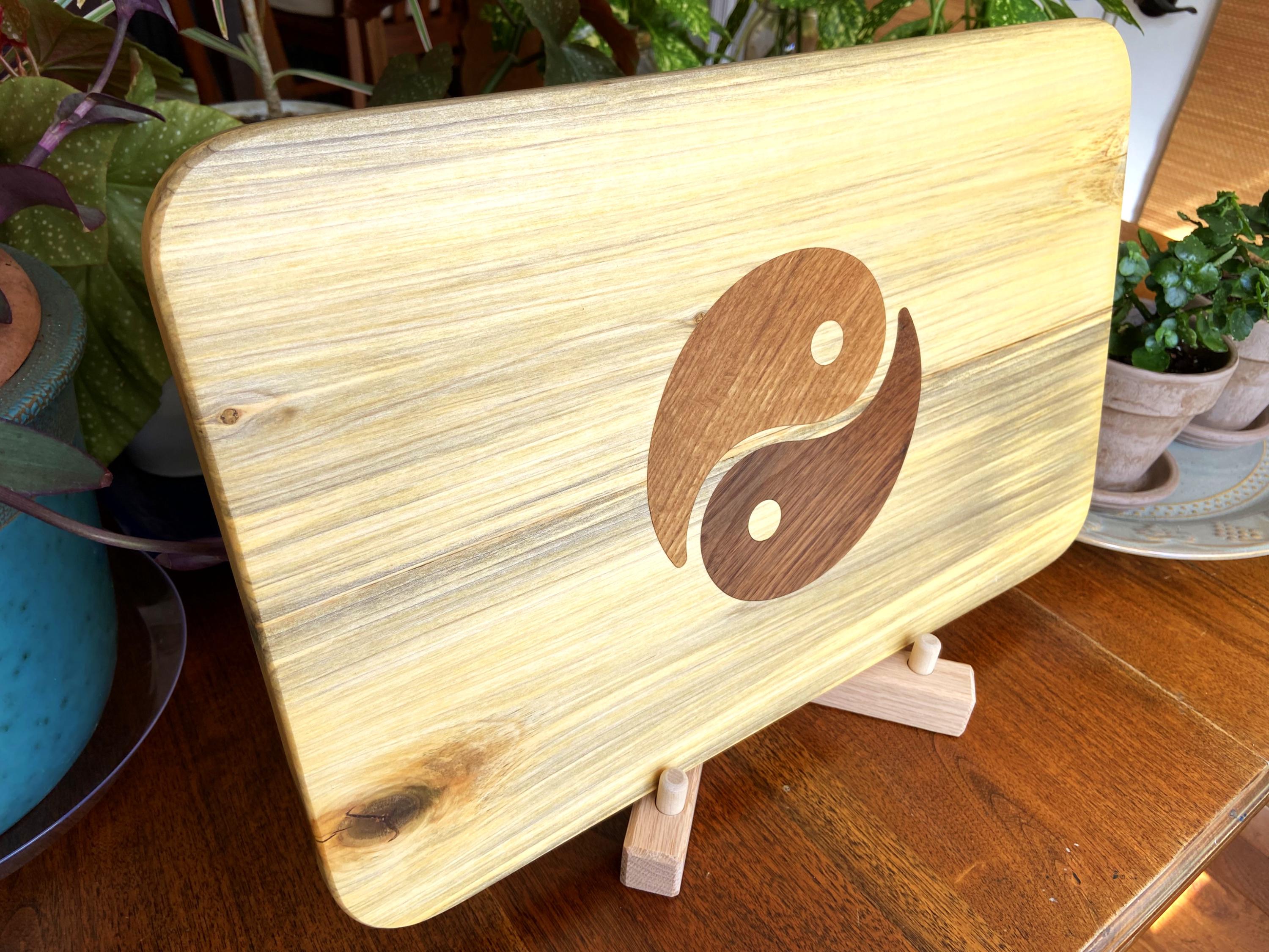 Poplar charcuterie board with Yin Yang inlay made from White Oak and Peruvian Walnut.