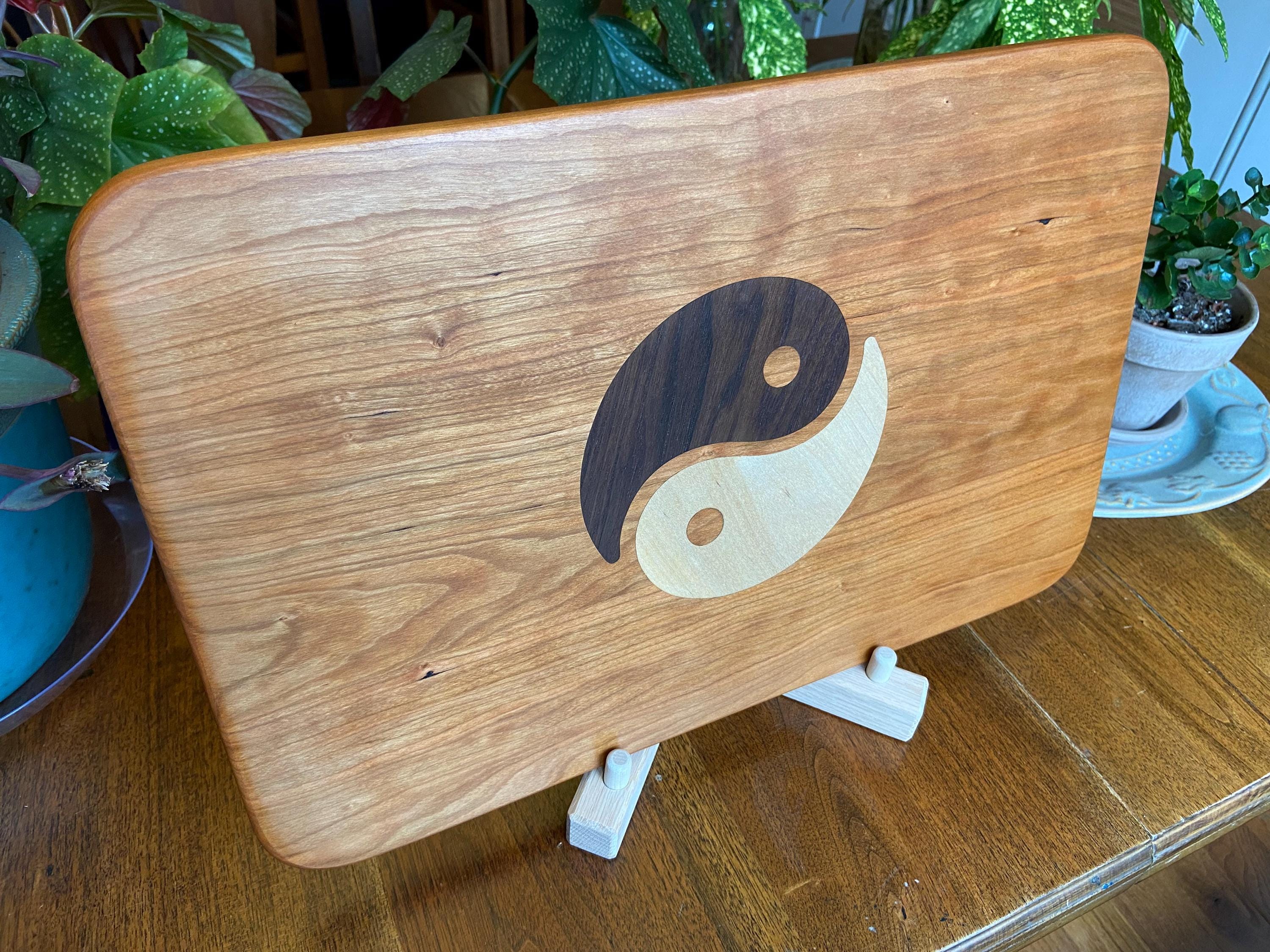 Cherry charcuterie board with Yin Yang inlay made from Peruvian Walnut and Maple.