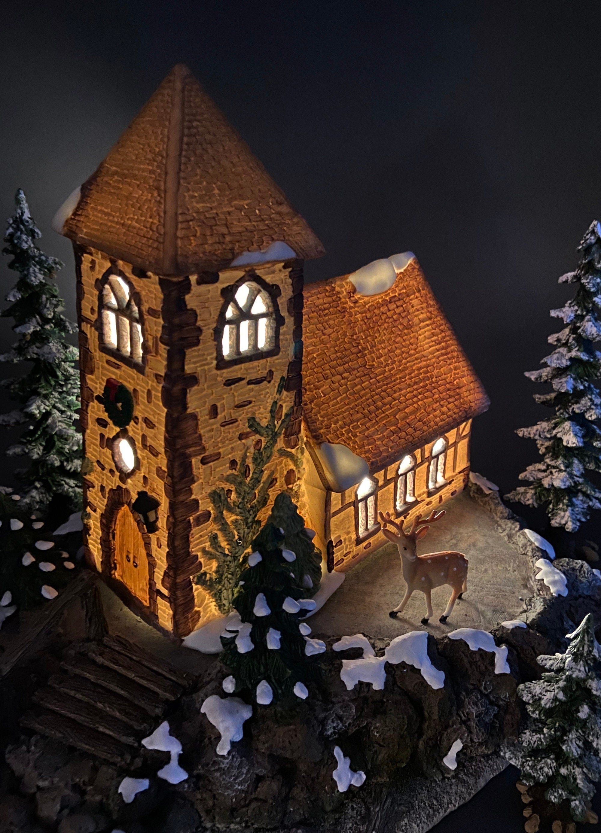 Christmas Village Church with Stained Glass Window. Illuminated House of Worship. Holiday Decor. Christmas Celebration.