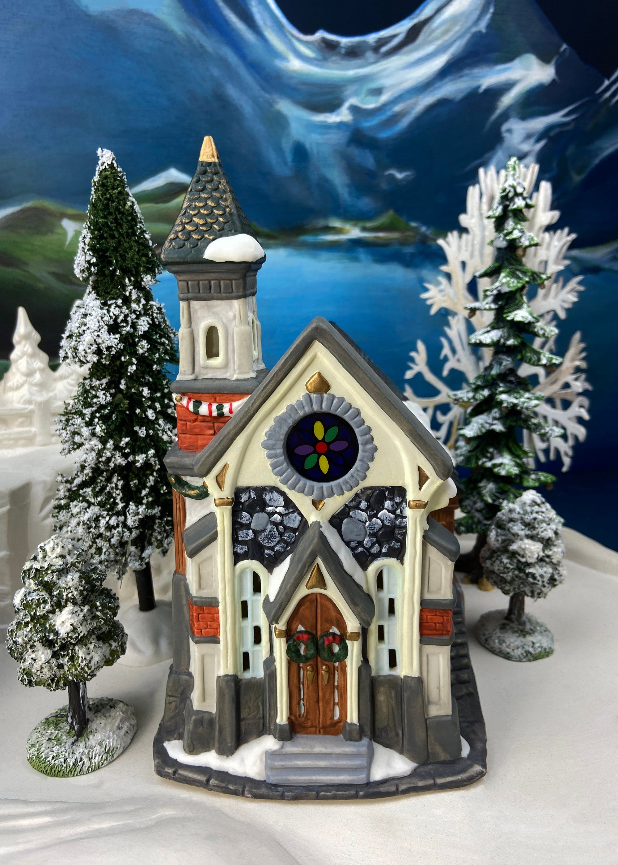 Christmas Village Church with Stained Glass Window. Illuminated House of Worship. Holiday Decor. Christmas Celebration.